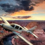 white, gold and burgundy Cessna over the Grand Canyon